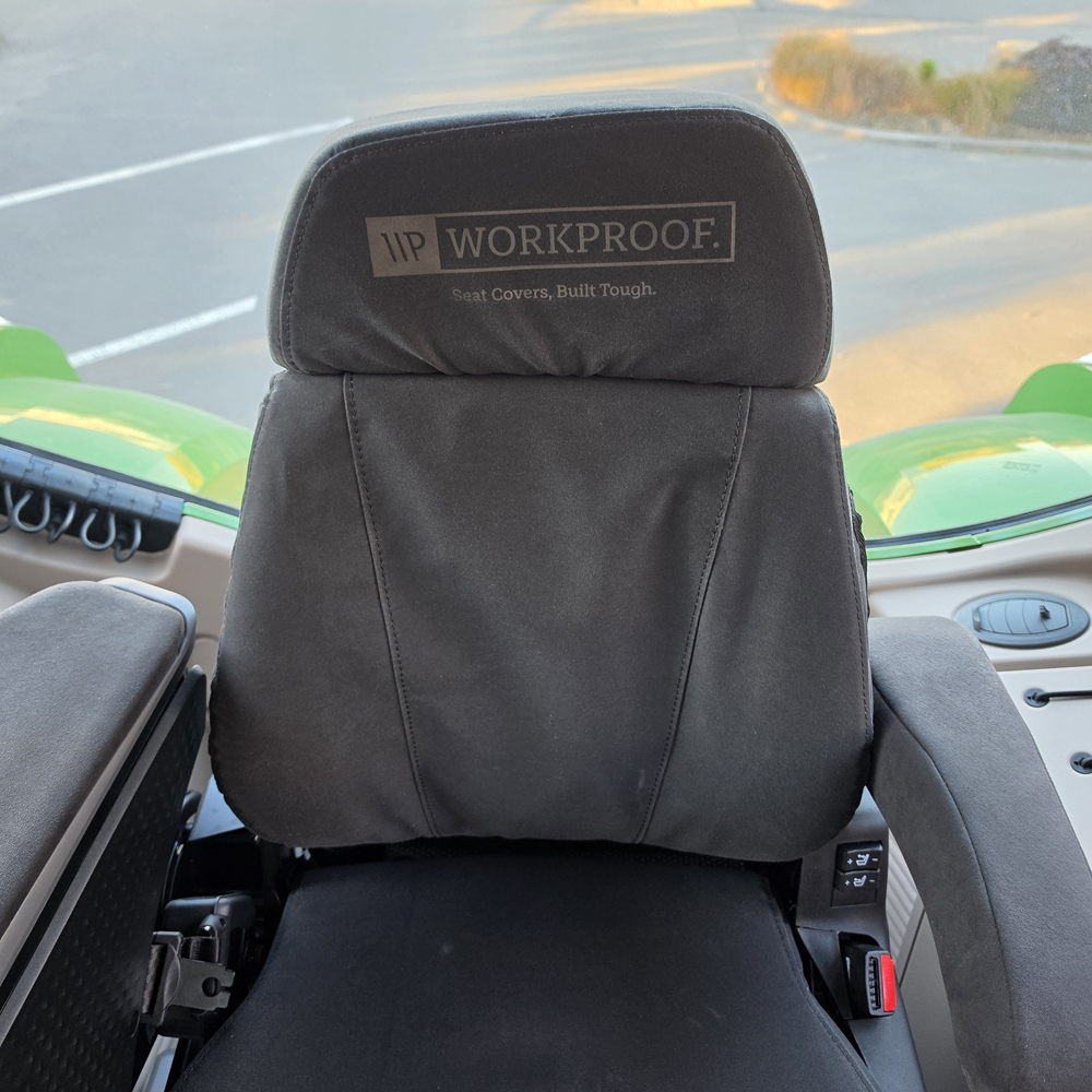 Front view of a Grammer MAXIMO XT Evolution MSG97EL/741 tractor seat fitted with a black WorkProof heavy-duty canvas seat cover, providing durable protection and a factory-style fit for agricultural machinery.