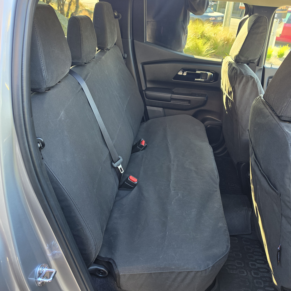 Mitsubishi Triton 2024 rear seat covers in heavy-duty black canvas, custom-fitted to protect the rear bench seat with a durable, waterproof, factory-style fit.