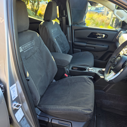 Mitsubishi Triton 2024 front seat covers in heavy-duty black canvas, custom-fitted for a factory-style fit with durable waterproof protection for work and everyday use.