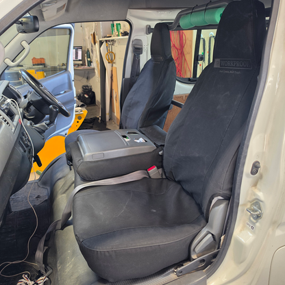 Toyota Hiace 2004 passenger view with black WORKPROOF waterproof canvas seat covers fitted, showing front seats and centre console folded down with factory-style fit