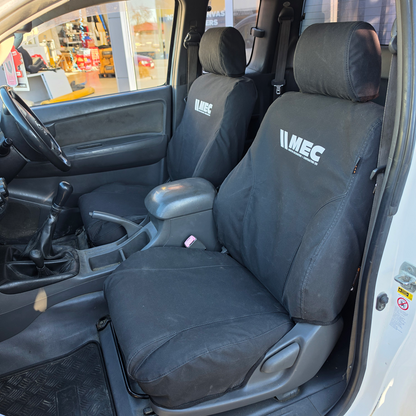 Toyota Hilux 2010–2015 front seats fitted with WORKPROOF heavy-duty waterproof canvas seat covers, factory-style fit designed for hard-working ute interiors