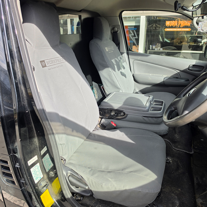 WORKPROOF Nissan NV350 canvas seat covers with centre armrest folded down showing factory-style fit and access functionality